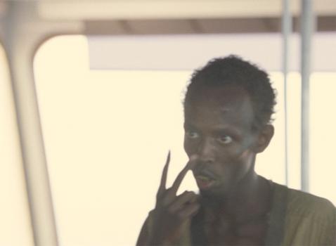 The hijacker in Captain Phillips points to his eyes while taking command.