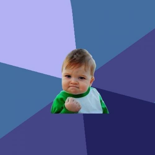 A toddler clenches his fist with a triumphant expression.